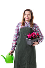 portrait of smiling woman professional gardener or florist in apron holding flowers in a pot and gardening tools  isolated on white background