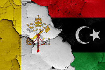flag of Vatican and Libya painted on cracked wall