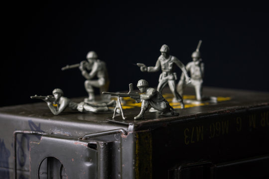Toy soldiers displayed on ammunition can