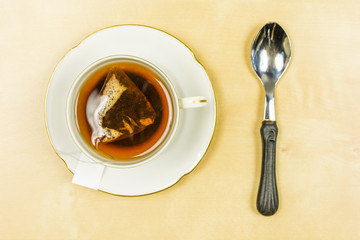 A cup of freshly brewed tea from a bag. View from above.