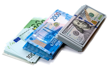 Packs of money in three currencies