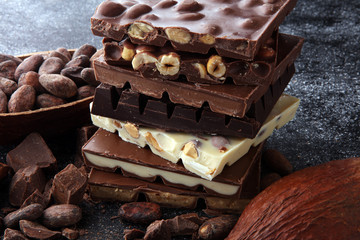 Chocolate bars on dark background with chocolate tower