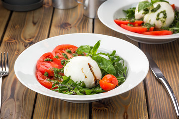 Buratta with fresh tomatoes and pesto sauce