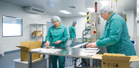 Pharmaceutical factory workers in sterile environment