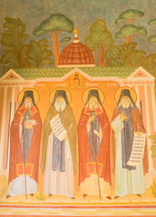 The ancient frescoes on the walls of the monastery depict the Optina holy elders