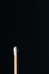 Matchstick isolated in black copy space