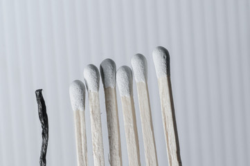 Grouped grey matchsticks in a row