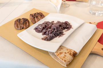 Piadina Romagnola with sausage and onion
