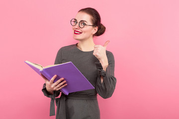 Businesswoman with hair bun and book