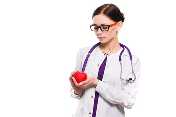 Young beautiful female doctor holding heart in her hands on white background