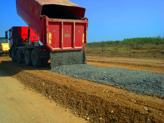 View of dump truck dumping gravel