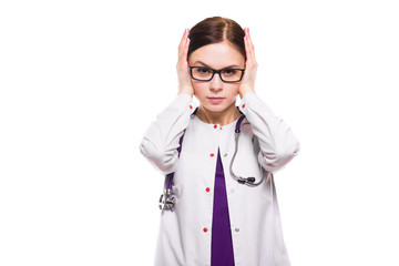 Young beautiful frustrated female doctor covering ears with her hands as need of silence concept on white background