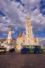 Fototapeta na wymiar Matthias Church in Budapest city, Hungary. wide view and bus in the frame
