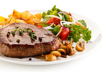 Grilled beefsteak with baked potatoes and vegetables