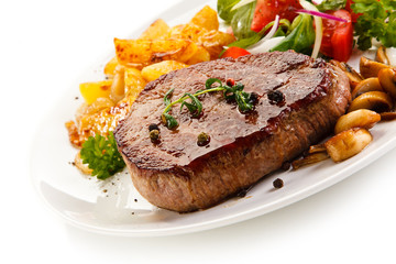 Grilled beefsteak with baked potatoes and vegetables