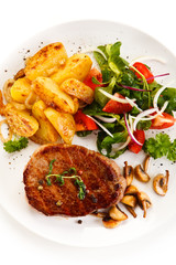 Grilled beefsteak with baked potatoes and vegetables