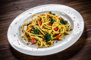 Pasta with collard on wooden table
