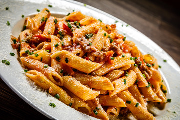Penne with meat, tomato sauce and vegetables