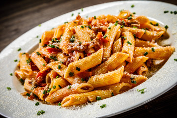 Penne with meat, tomato sauce and vegetables