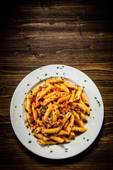Penne with meat, tomato sauce and vegetables