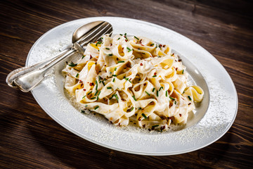Pasta carbonara on wooden table