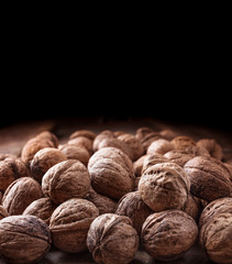 Walnuts large closeup group in peel on dark background