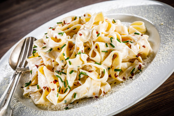 Pasta carbonara on wooden table