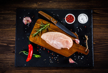 Raw chicken fillet on wooden table 