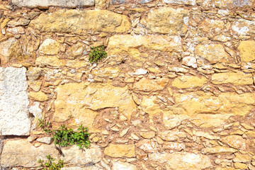 Old brown wall with stone masonry, background