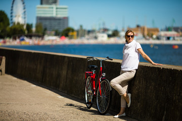 Woman and bike on pier 