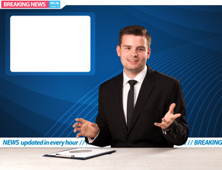 Television reporter telling breaking news at his studio desk with copy space