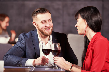young man and woman celebrating in restaurant