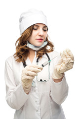 young girl nurse in glasses prepares syringe