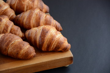 Fresh croissant on a black background.  