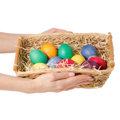 Easter color eggs in the basket in hand