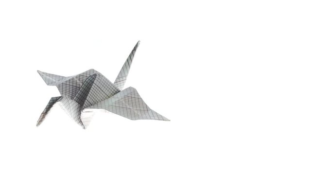 Beautiful heron origami crane animated flying to the left corner on a white background. 4K video