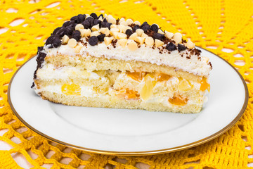Delicious piece of cake with fruit, whipped cream and chocolate drops