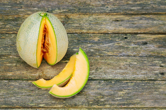 Fresh melons sliced on wooden table