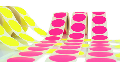 Colored label rolls isolated on white background with shadow reflection. Color reels of labels for...