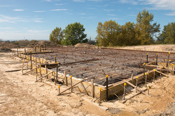 Fototapeta na wymiar Reinforcing metal bars on foundation and floor ready for pooring concrete