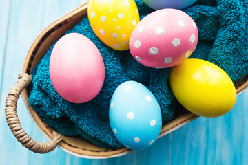 Fototapeta na wymiar Easter eggs in the basket on rustic background