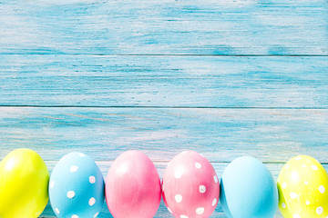 Colorful Easter eggs on blue rustic background