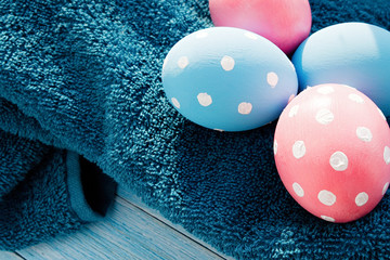 Pastel color Easter eggs on rustic background