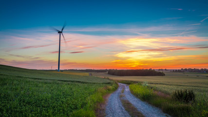 Fototapeta na wymiar Stunning dusk over field wind turbines, Poland