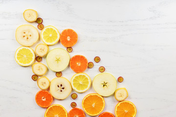 Mix of colored fruits on white wooden background - Composition of tropical healthy eating and food background