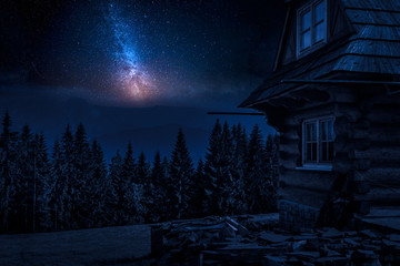 Rural cottage and milky way in the mountains at night