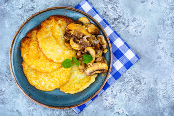 Hot potato pancakes with fried mushrooms