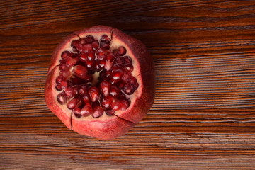 fresh organic pomegranate on wood background