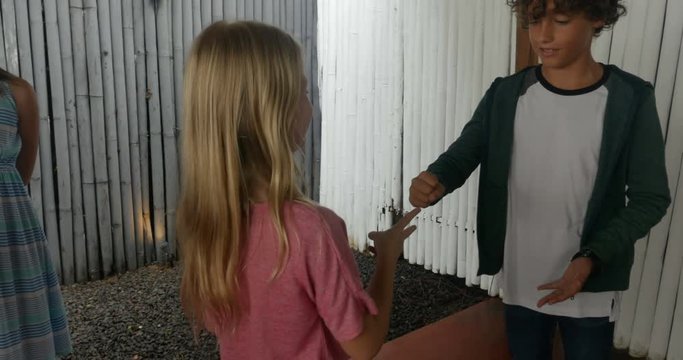 A boy and girl play rock paper scissors a game of chance