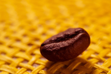 roasted, fragrant coffee grains macro on yellow background